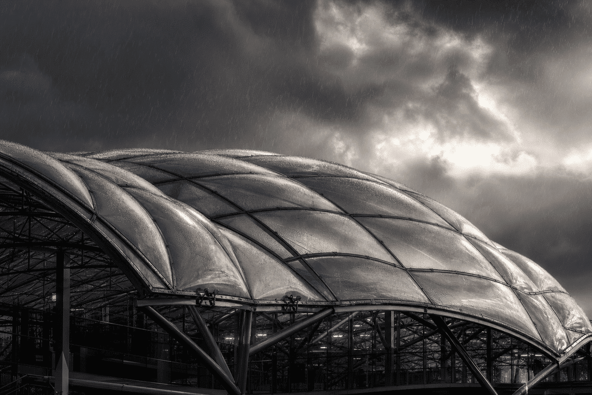 ETFE airport roof under dramatic storm lighting and rain