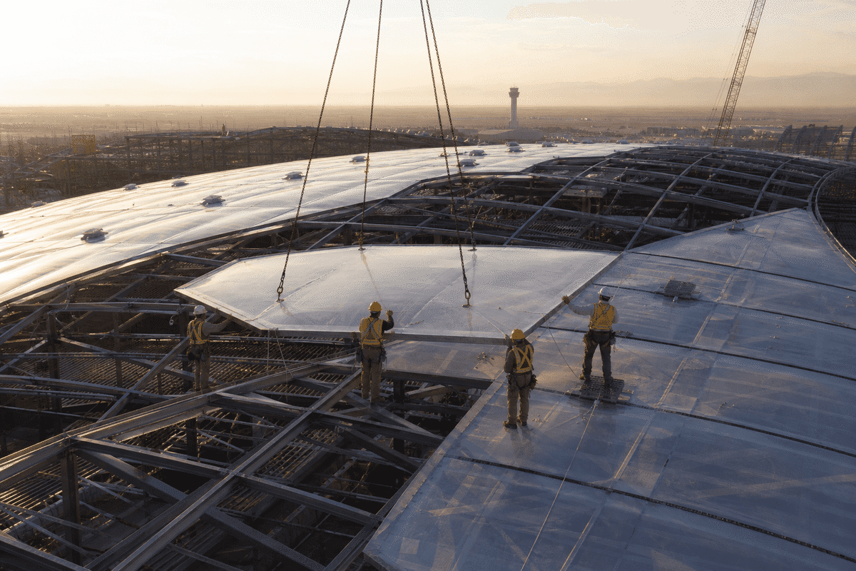 Construction stage installing ETFE modules on airport steel grid