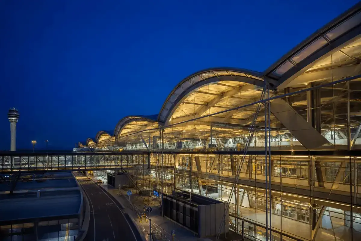 Night view of airport terminal softly glowing through ETFE roof — Airport ETFE Roofing systems
