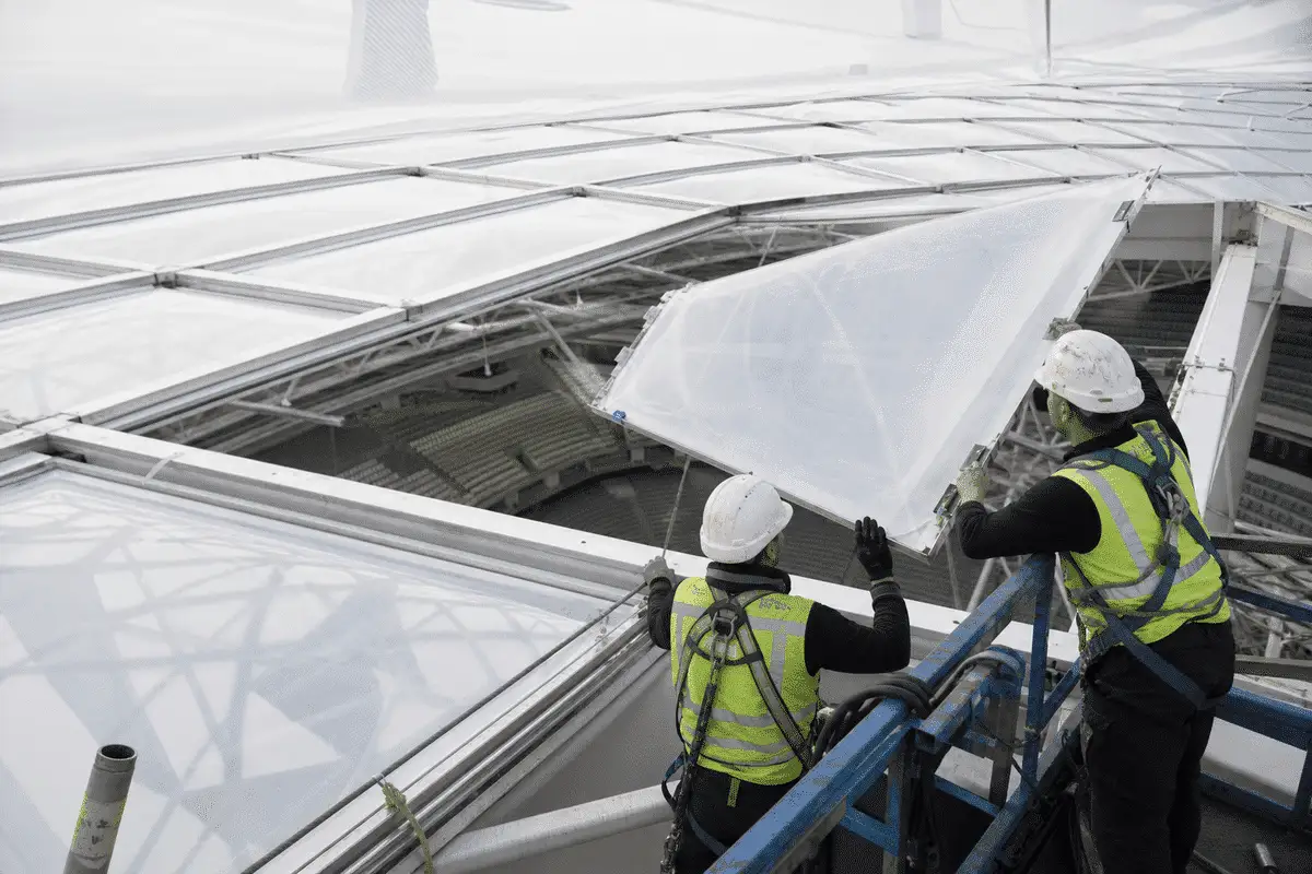 Construction crew installing ETFE modules on roof grid — Indoor Sports Arena ETFE Roofing