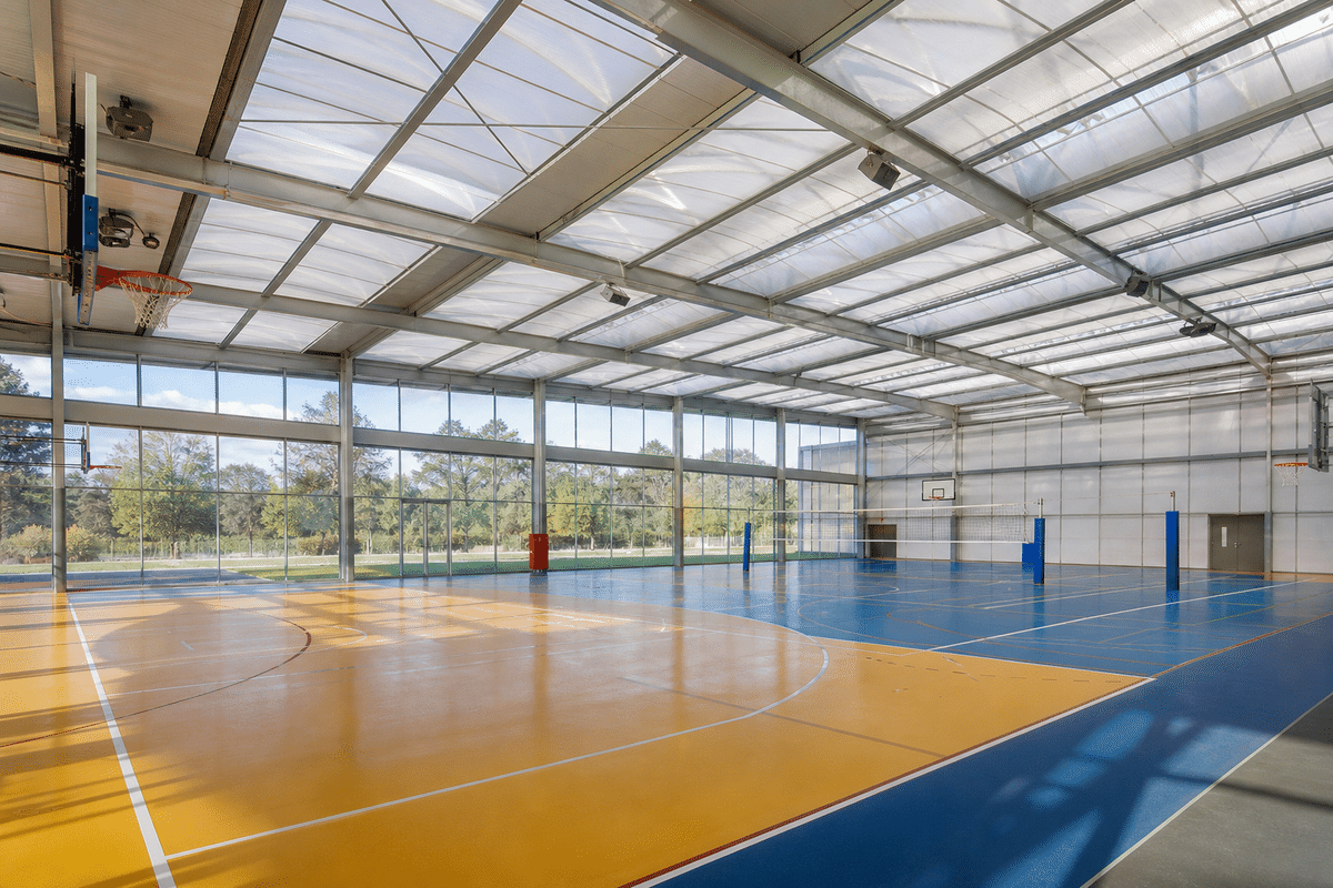 Natural daylight washing a sports complex hall through an ETFE roof