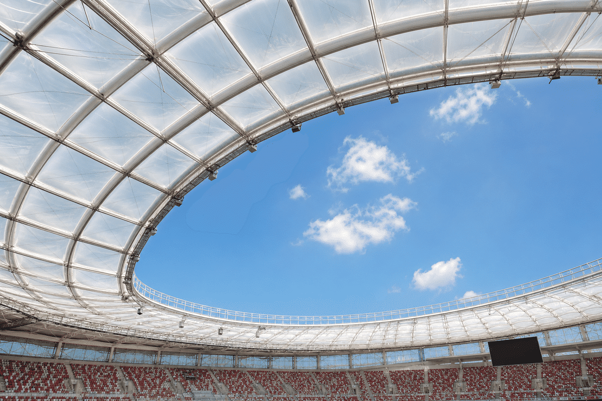 Stadium interior looking up at a daylit ETFE cushion roof