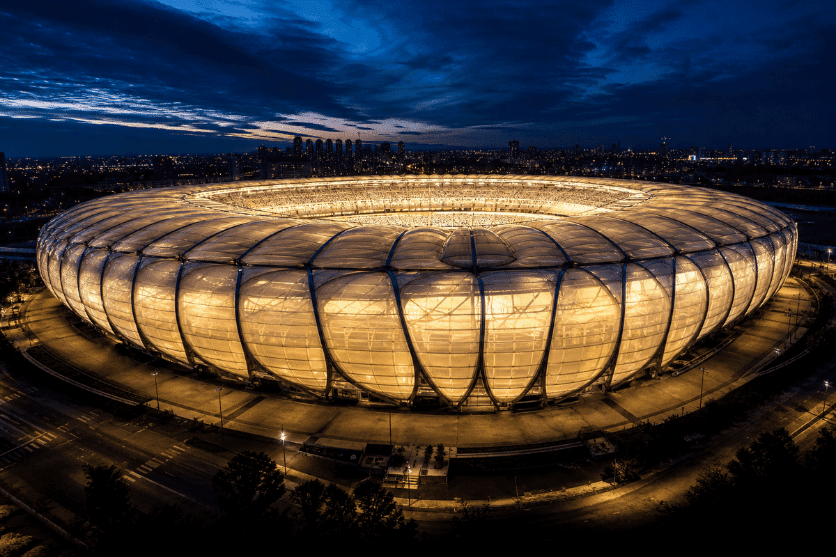 Night view of stadium softly glowing through ETFE roof