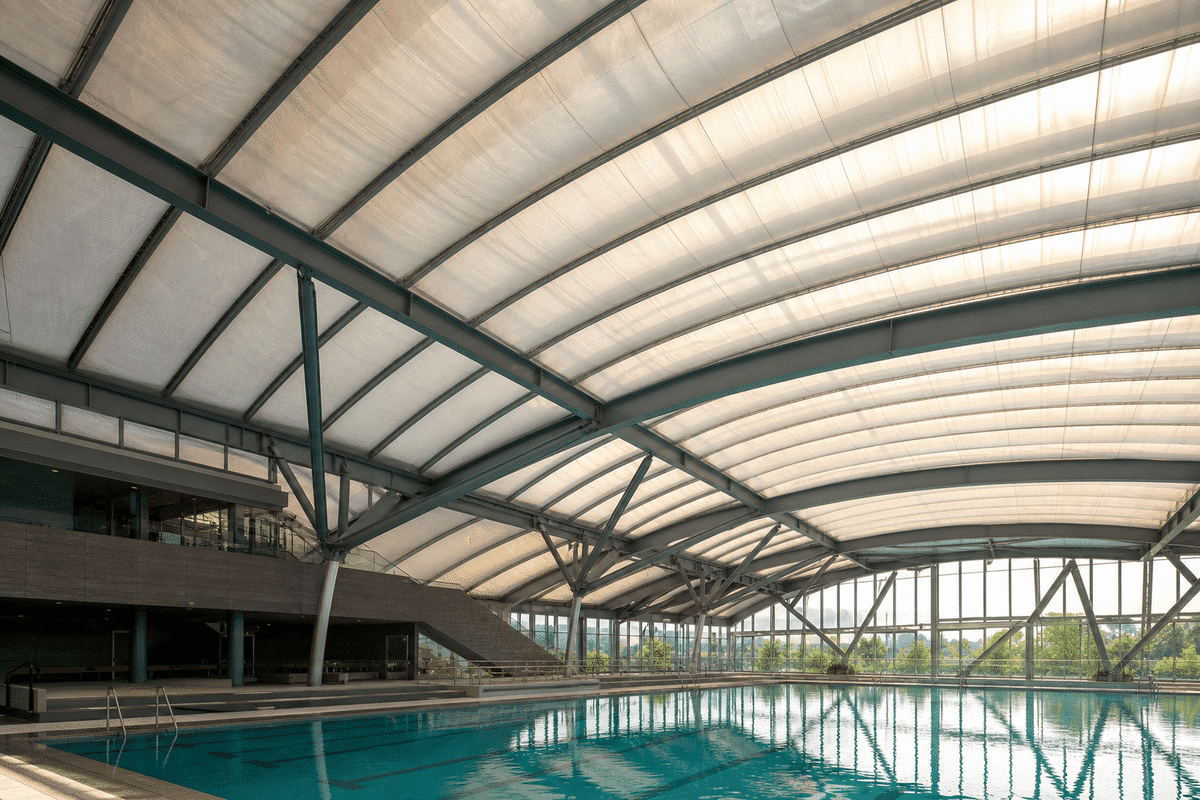 Interior looking up at a daylit ETFE cushion roof in an indoor swimming pool aquatic centre with ETFE roof