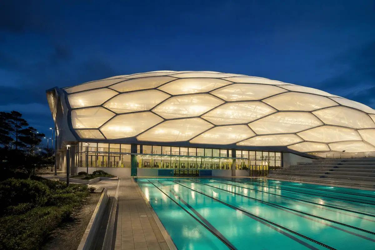 ETFE roof glowing softly at night — Swimming Pool ETFE Roofing