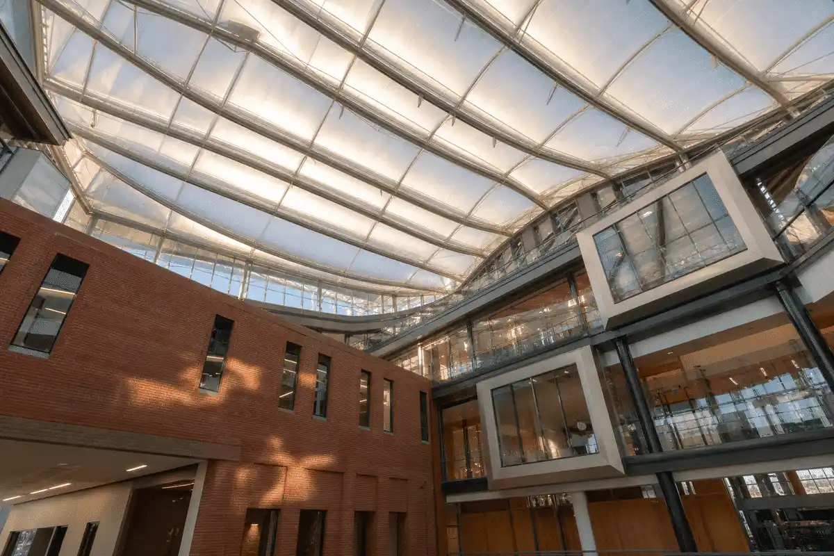 Interior looking up at a daylit ETFE cushion roof in a modern university campus with ETFE roof