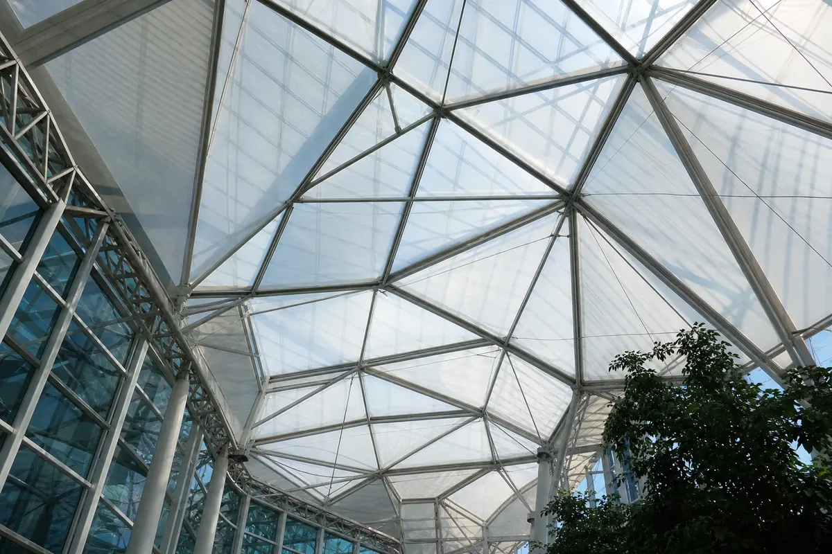 Airport terminal interior under a luminous ETFE film roof