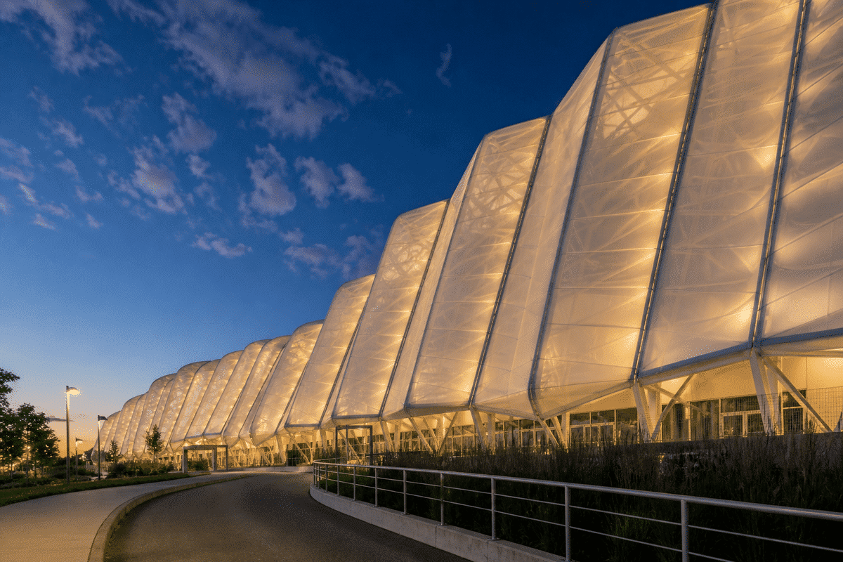 Shopping mall ETFE skylight glowing at twilight