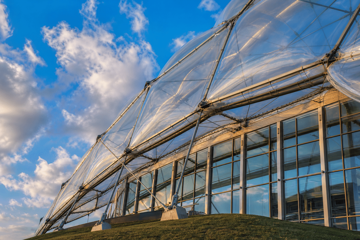 ETFE cushion roof modules on steel cable net against blue sky