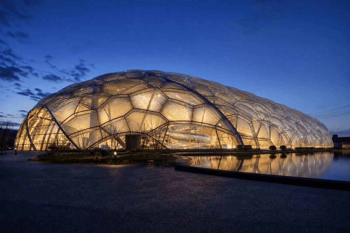Aquatic center multi-layer ETFE cushion dome at dusk