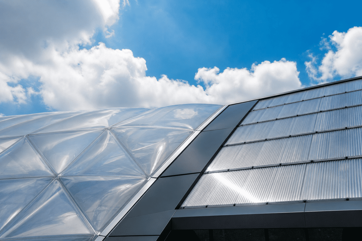ETFE cushion canopy contrasted with rigid polycarbonate panel roof